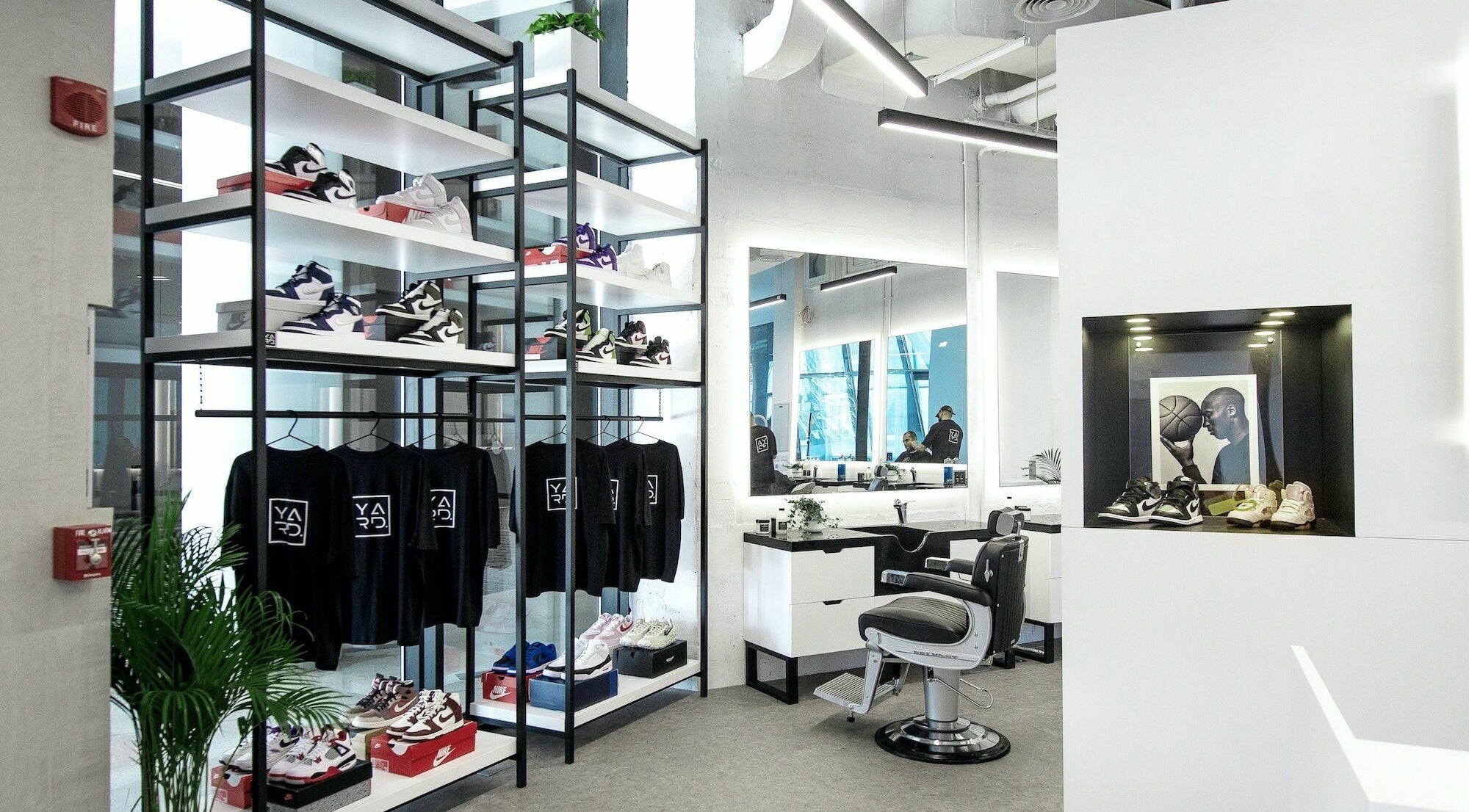 YARD Barber and Shop interior in Dubai, AE, showcasing trendy sneaker display and barber chair.