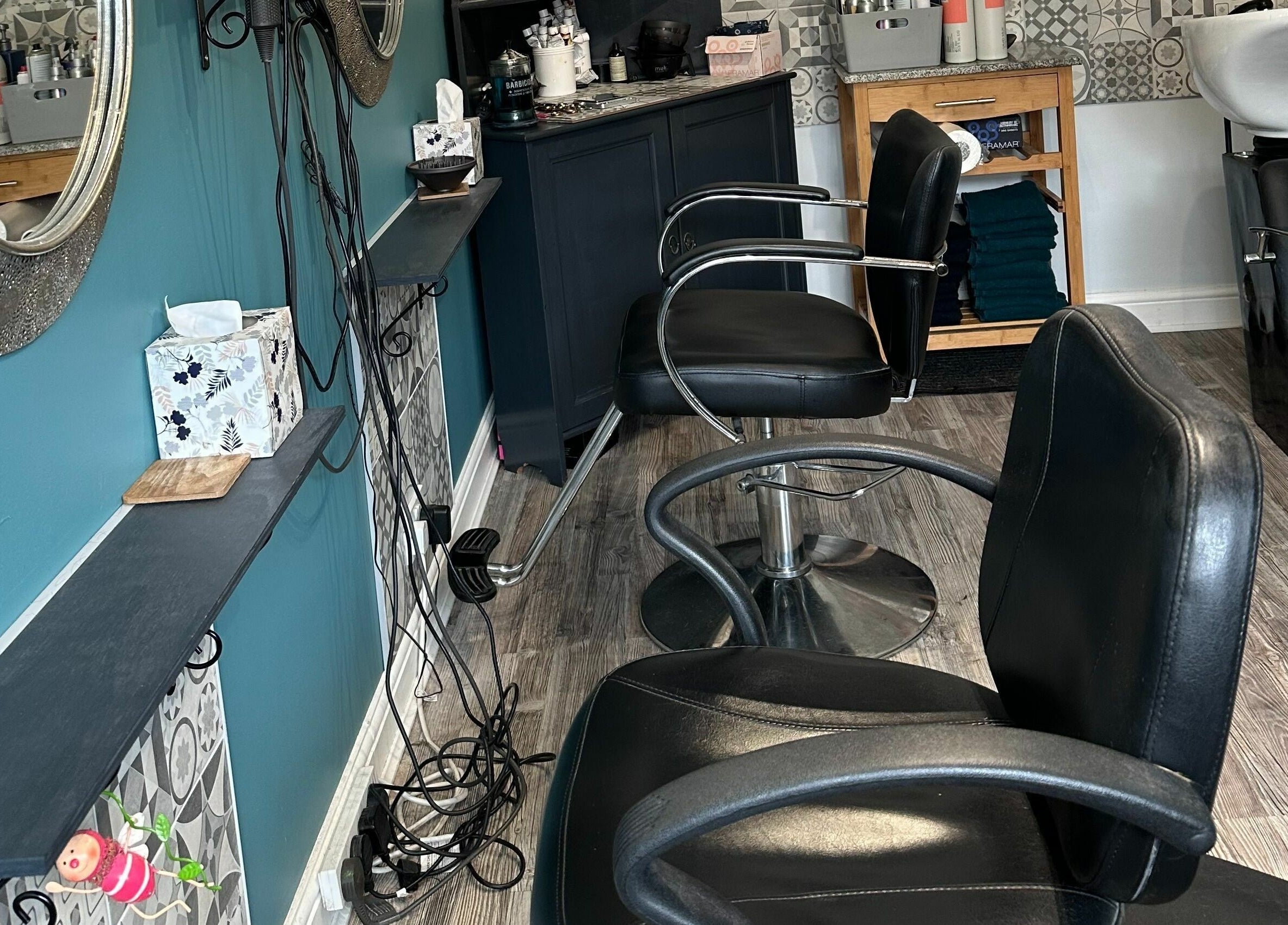 Modern salon interior at Xanadu, Wolston, England, GB, featuring stylish chairs and elegant decor.