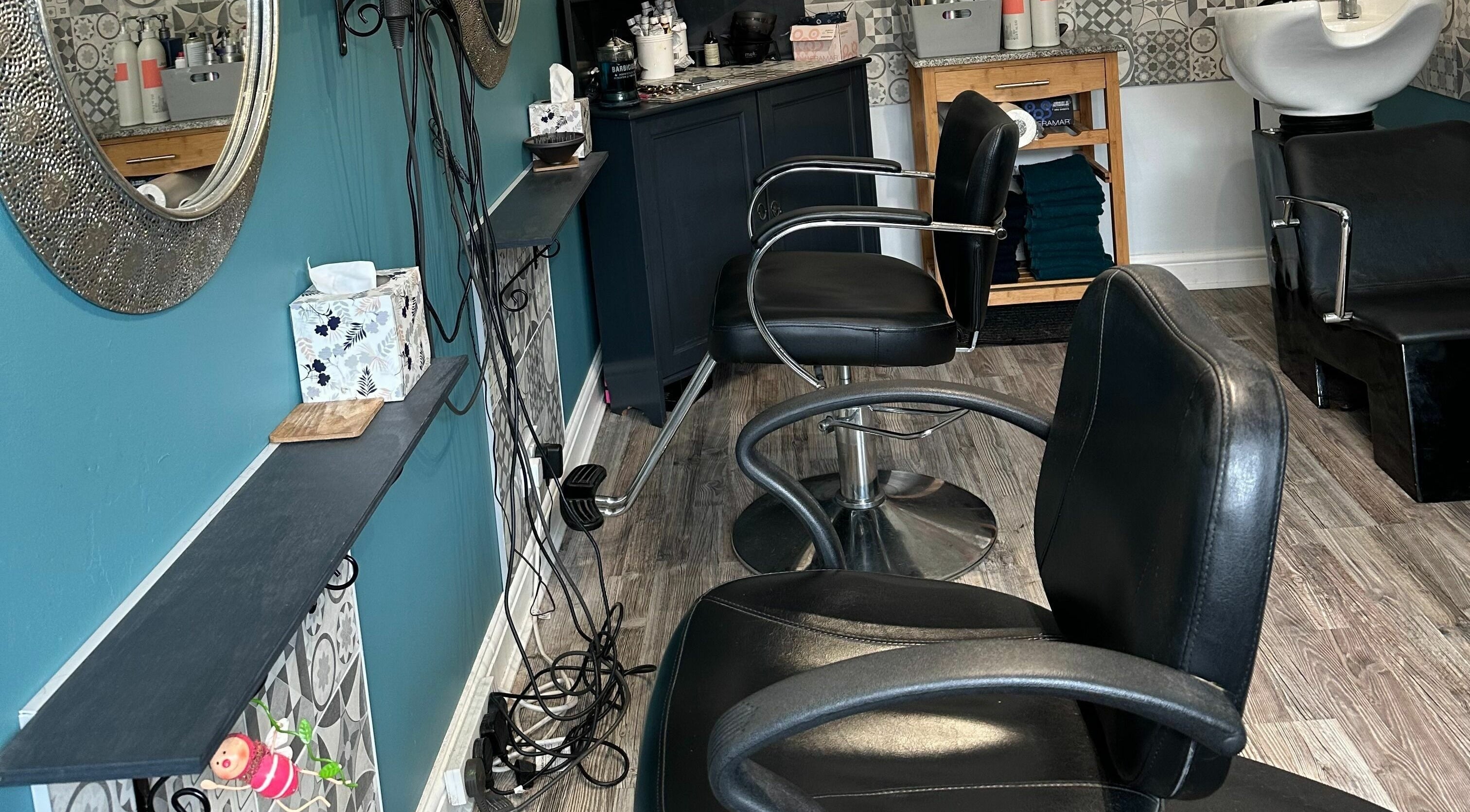 Modern salon interior at Xanadu, Wolston, England, GB, featuring stylish chairs and elegant decor.