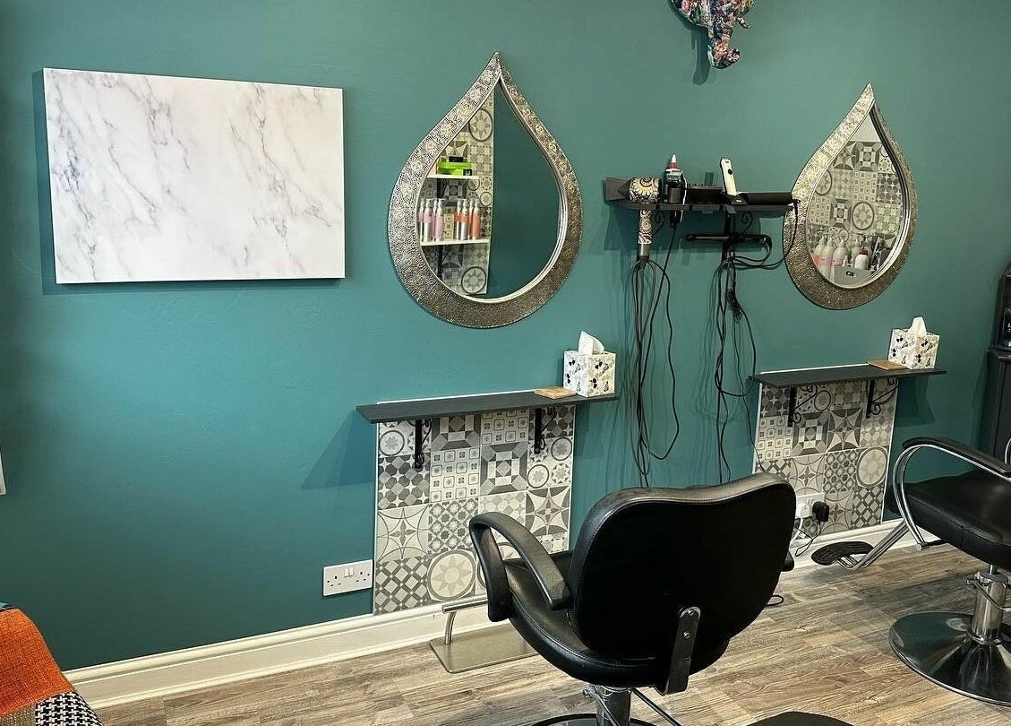 Inside Xanadu, Wolston, England, GB, a chic salon area with mirrors, chairs, and magazines creates a welcoming ambiance.