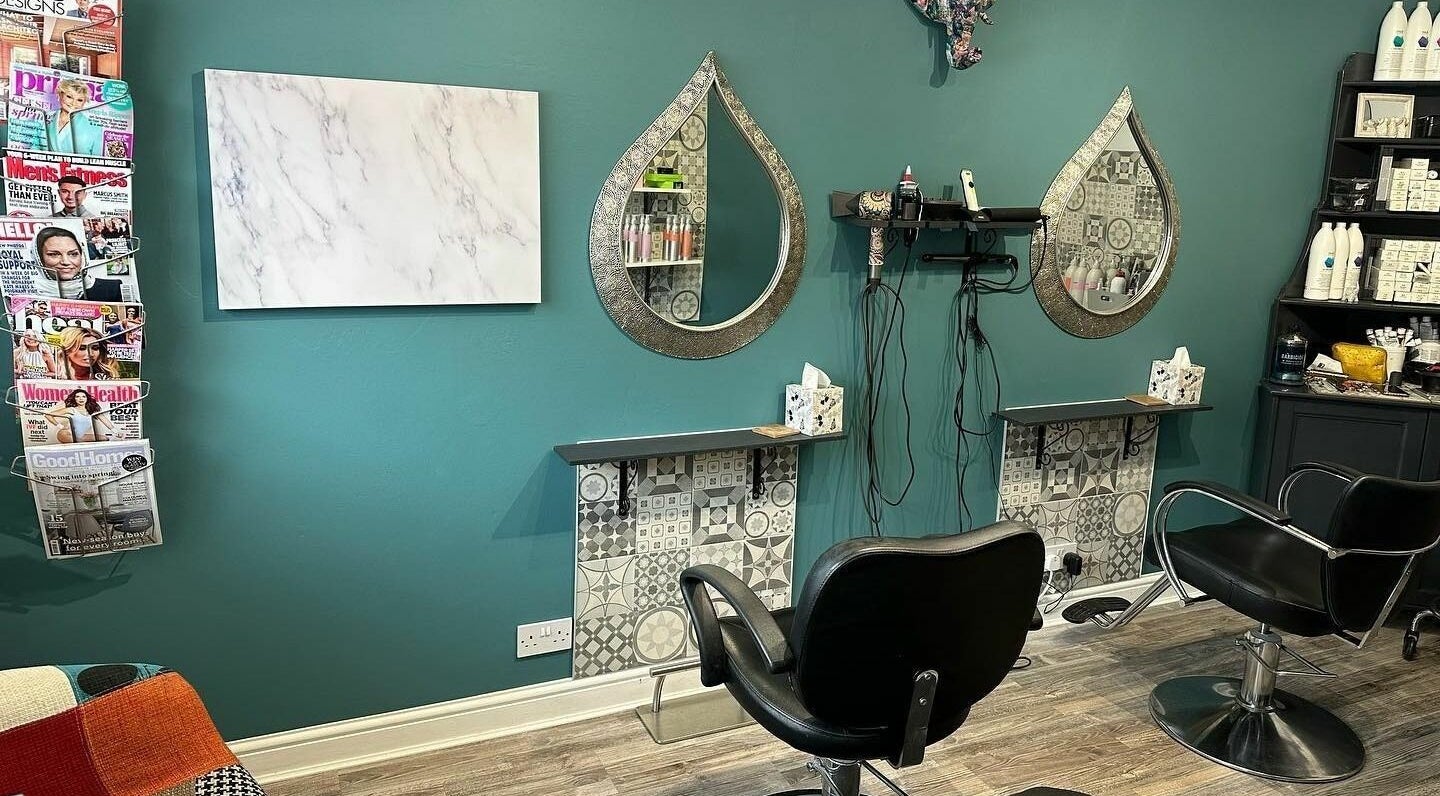 Inside Xanadu, Wolston, England, GB, a chic salon area with mirrors, chairs, and magazines creates a welcoming ambiance.