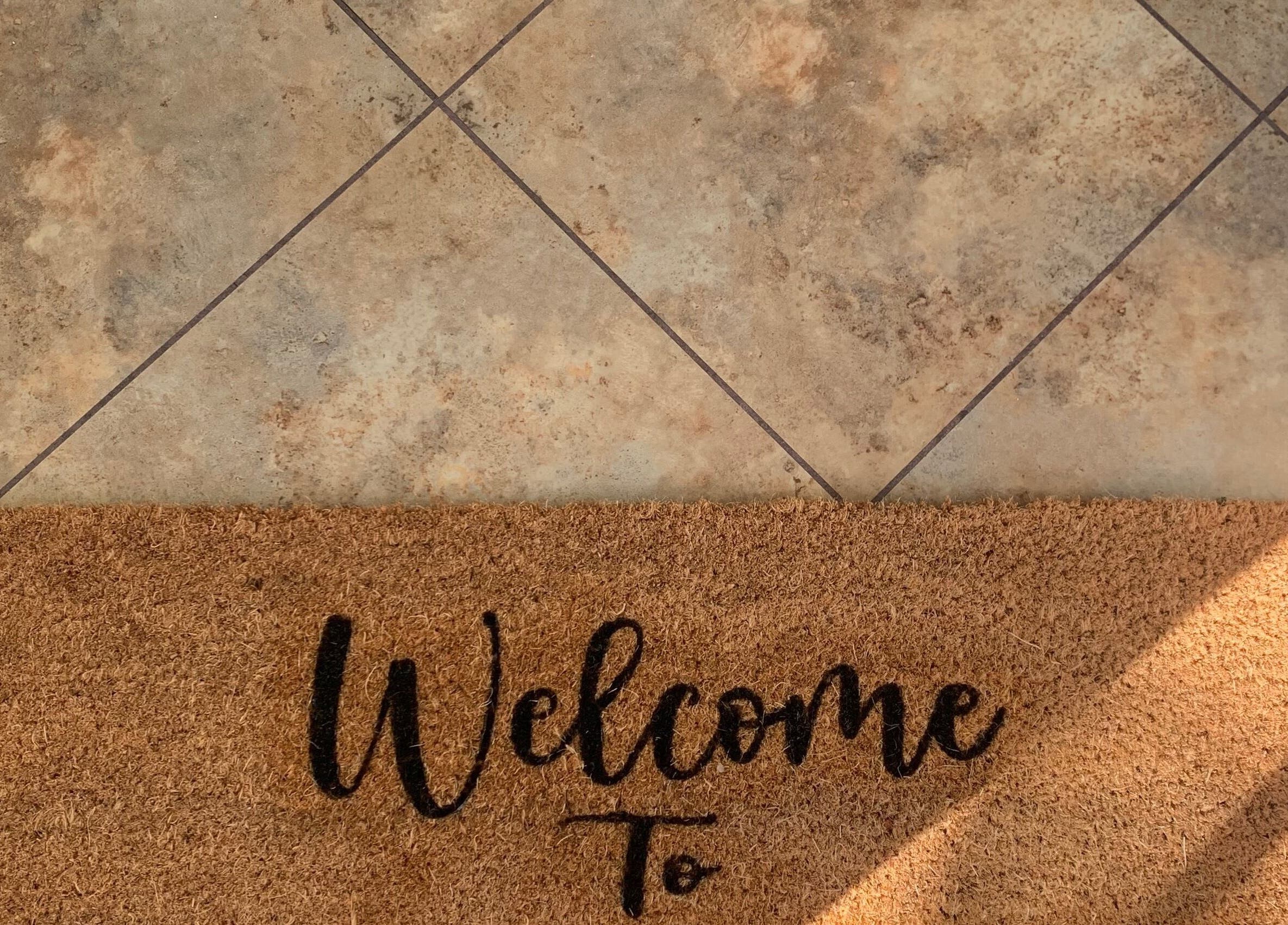 Welcome mat at Copper Cuts, Reading, England, GB entrance.