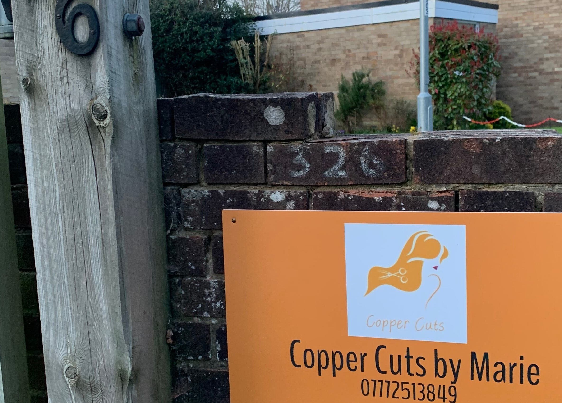 Entrance sign for Copper Cuts by Marie at 326, Reading, England, GB.