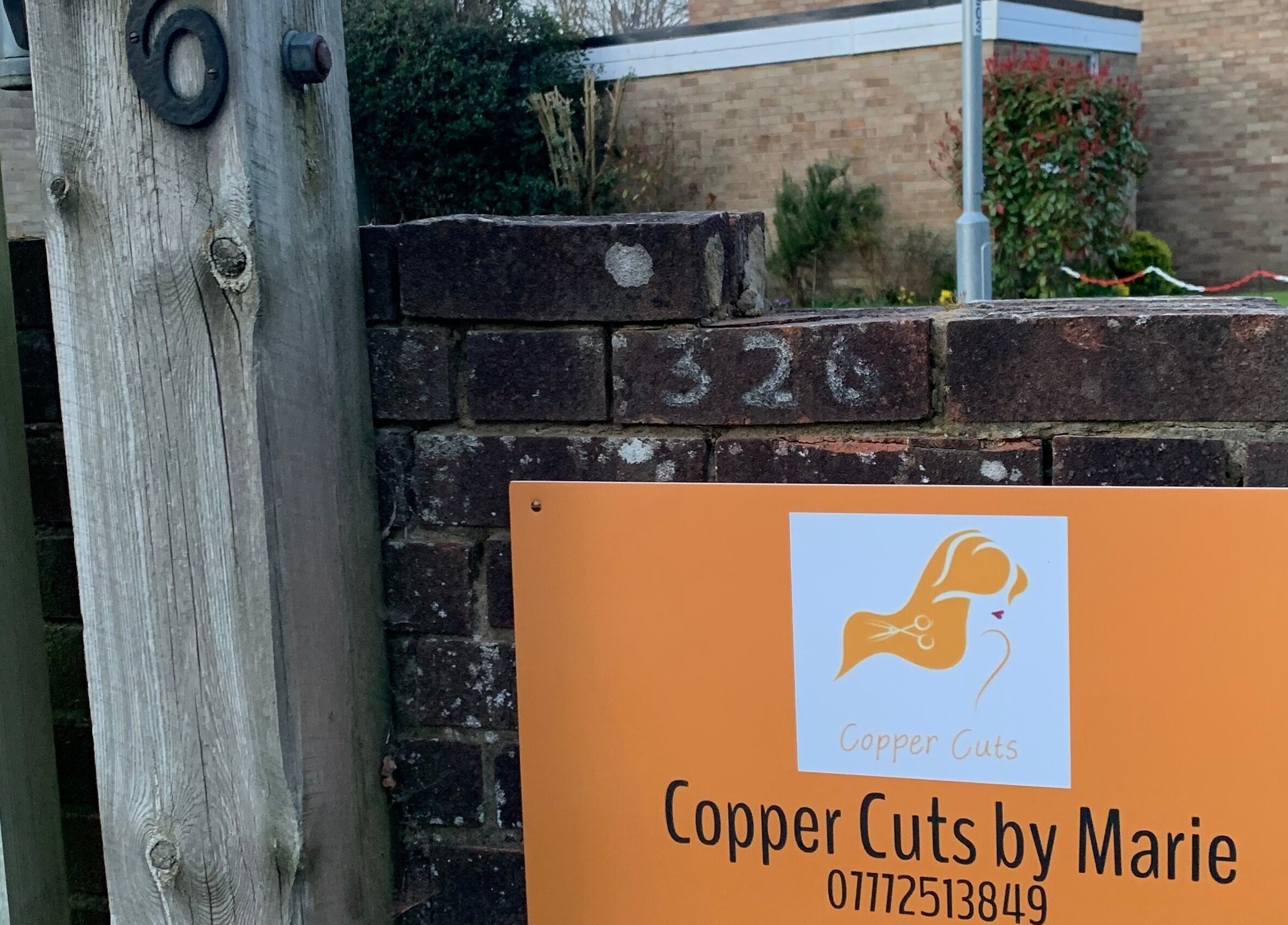 Entrance sign for Copper Cuts by Marie at 326, Reading, England, GB.