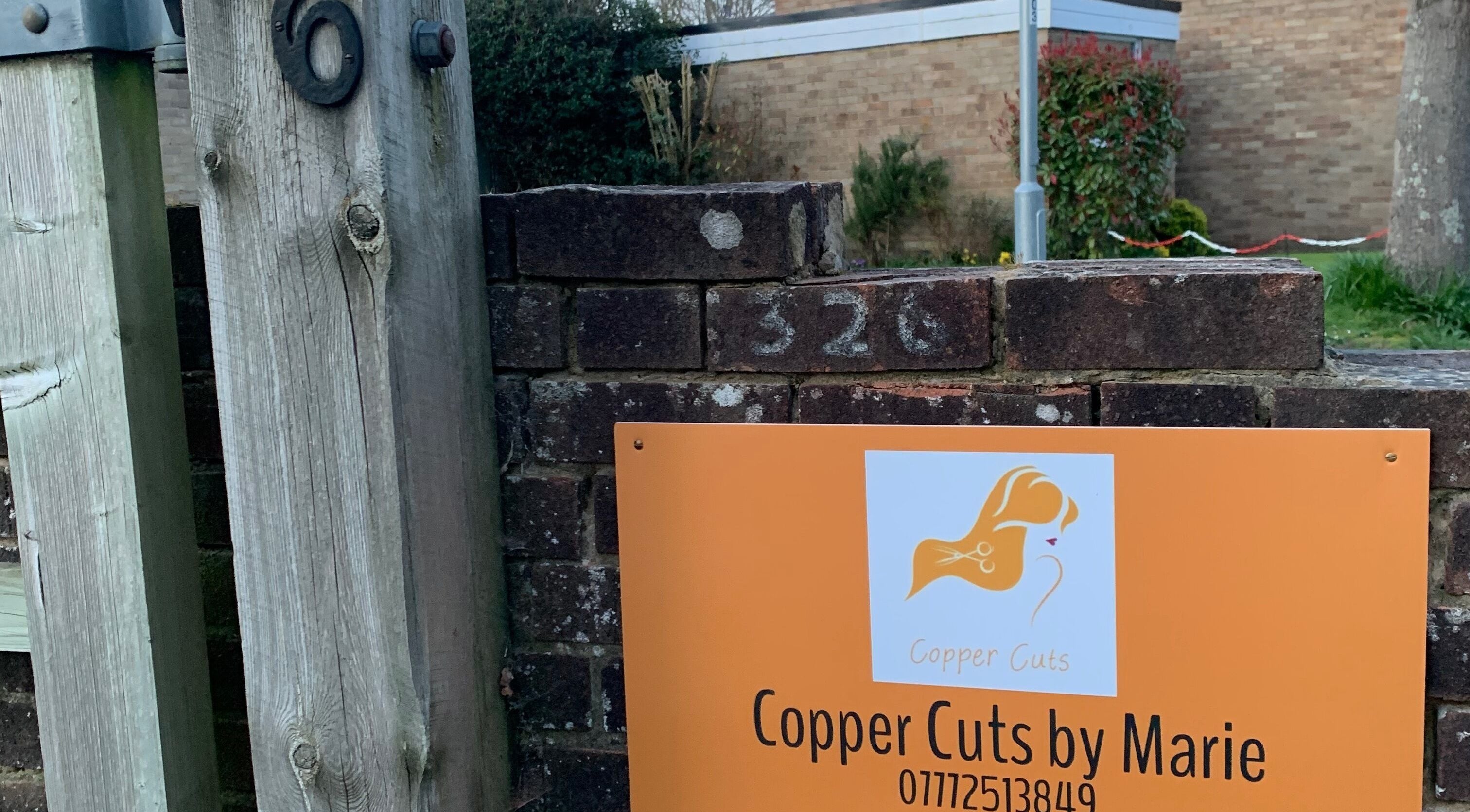 Entrance sign for Copper Cuts by Marie at 326, Reading, England, GB.