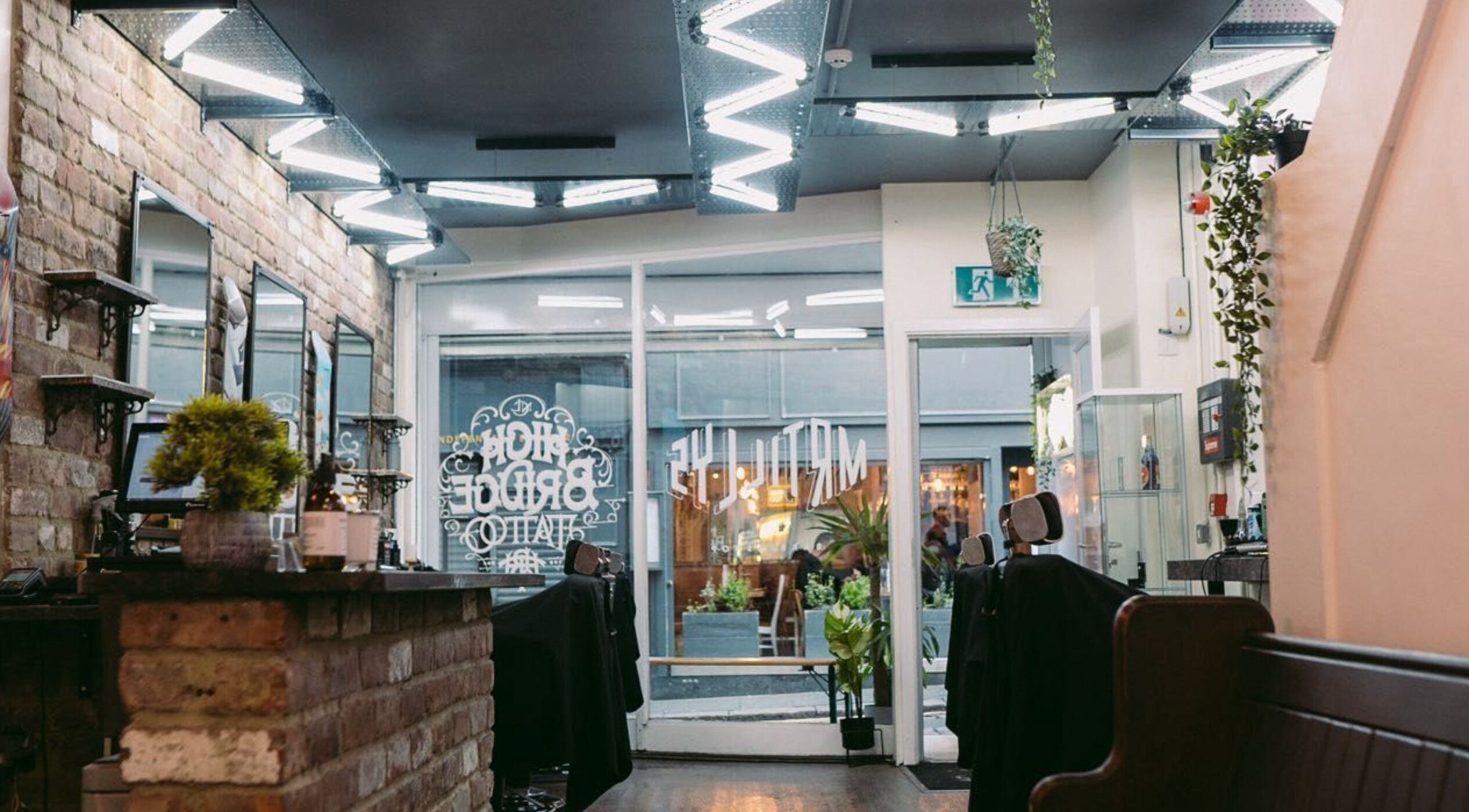 Interior of Mr Tillys Barbershop High Bridge in Newcastle upon Tyne, England, GB, featuring stylish decor and seating.