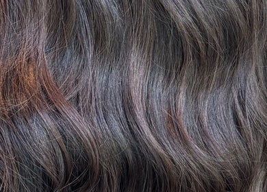 Lustrous wavy hair at Morgan Mc Adams Hairdressing in Nottingham, England, GB.