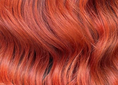 Vibrant red hair styled in soft waves at Morgan Mc Adams Hairdressing, Nottingham, England, GB.