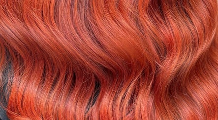 Vibrant red hair styled in soft waves at Morgan Mc Adams Hairdressing, Nottingham, England, GB.