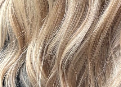 Flowing blond hair at Morgan Mc Adams Hairdressing, Nottingham, England, GB. Highlighting elegant salon styling.