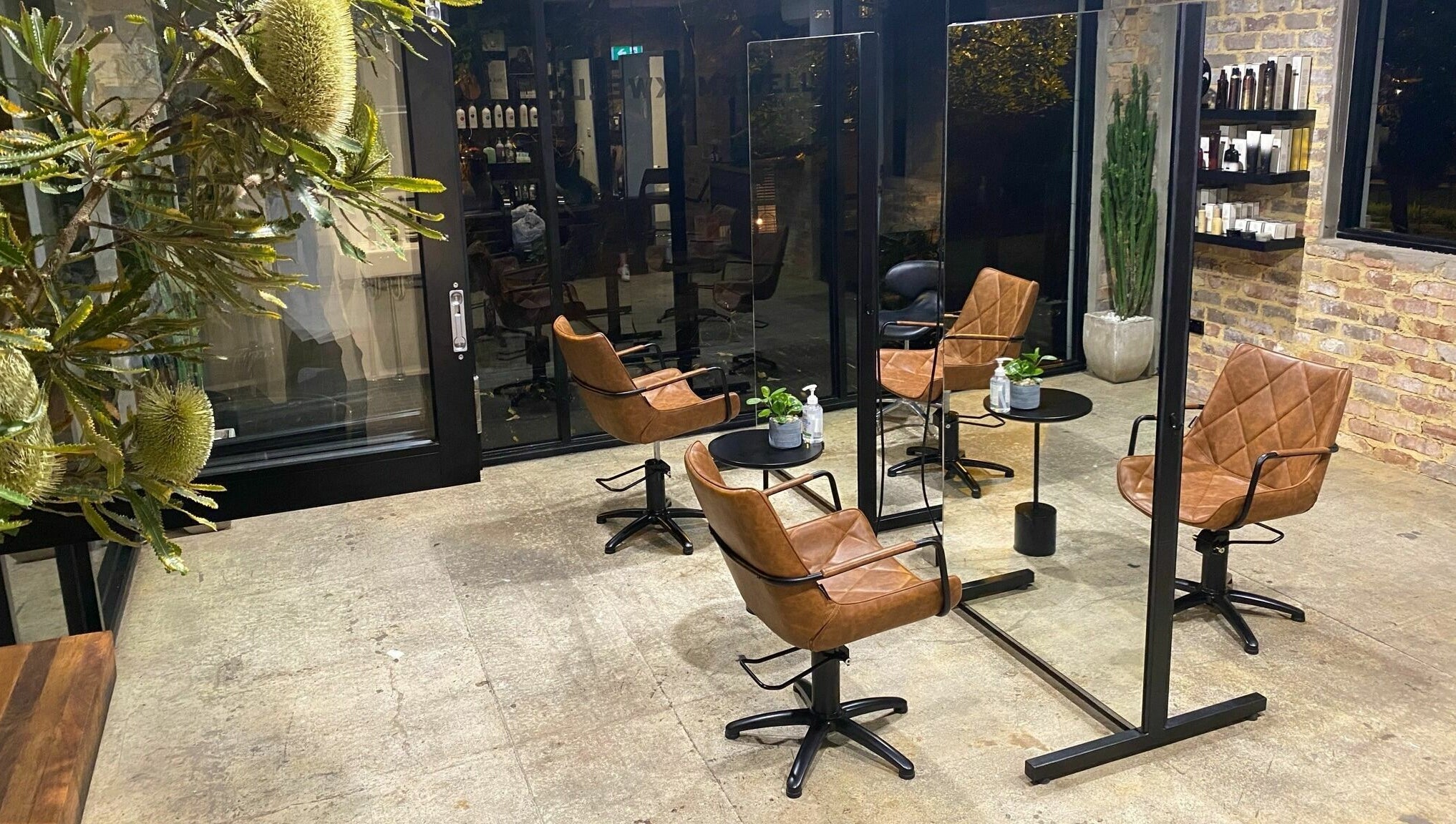 Stylish salon interior with leather chairs at Marc & Maxwell, Surry Hills, New South Wales, AU.