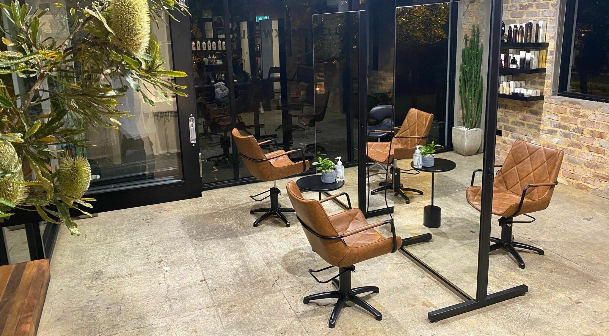 Stylish salon interior with leather chairs at Marc & Maxwell, Surry Hills, New South Wales, AU.