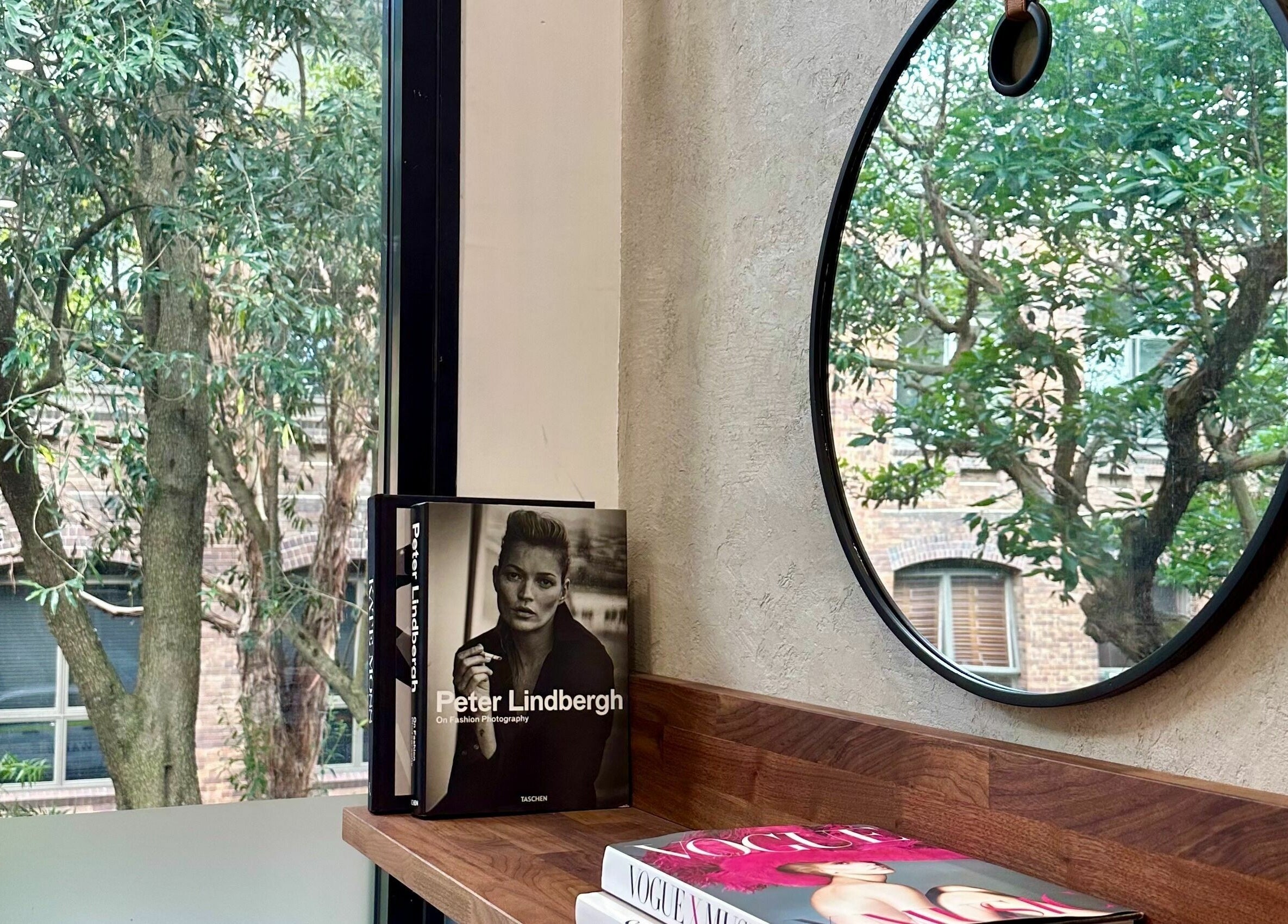 Stylish bench with books and mirror at Marc & Maxwell, Surry Hills, New South Wales, AU.