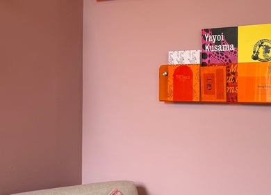A stylish wall with vibrant books at Solo Studio, Amble, England, GB, enhancing its chic interior design.