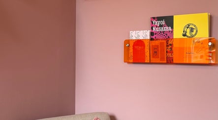 A stylish wall with vibrant books at Solo Studio, Amble, England, GB, enhancing its chic interior design.