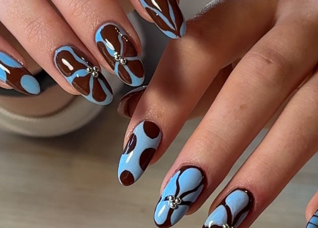 Stylish blue and brown nail art at Solo Studio Nails & Education in Amble, England, GB.