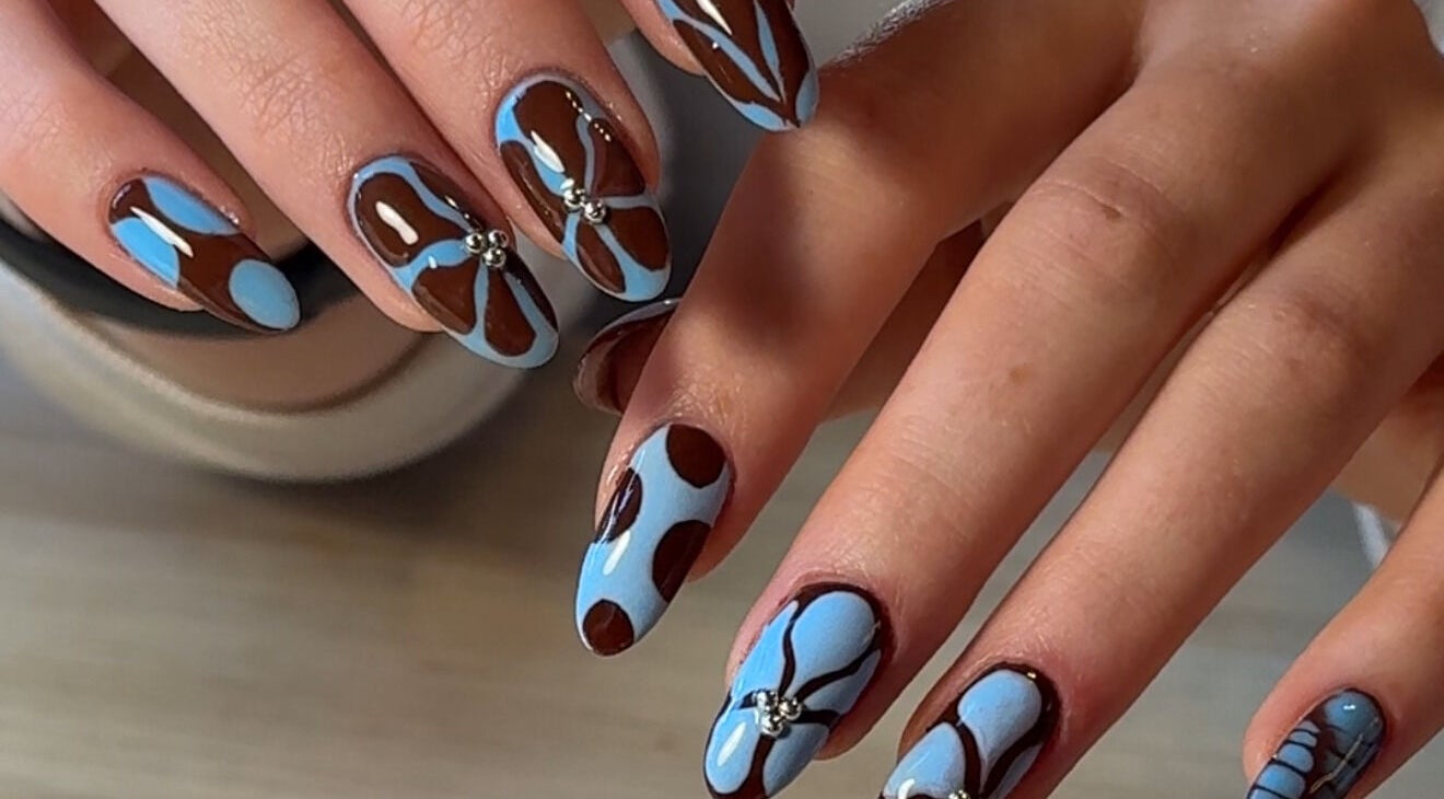 Stylish blue and brown nail art at Solo Studio Nails & Education in Amble, England, GB.