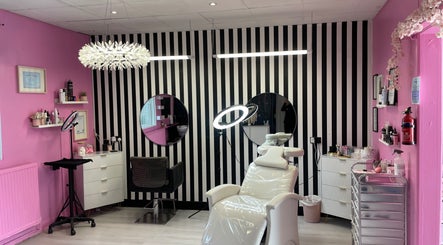 Interior of Bloom Nails and Beauty in Rochdale, England, GB, featuring stylish decor with pink walls and a treatment chair.