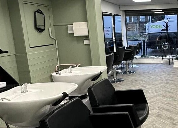 Modern salon interior at Ivy Studio, Shaw, England, GB, featuring stylish wash stations and seating.