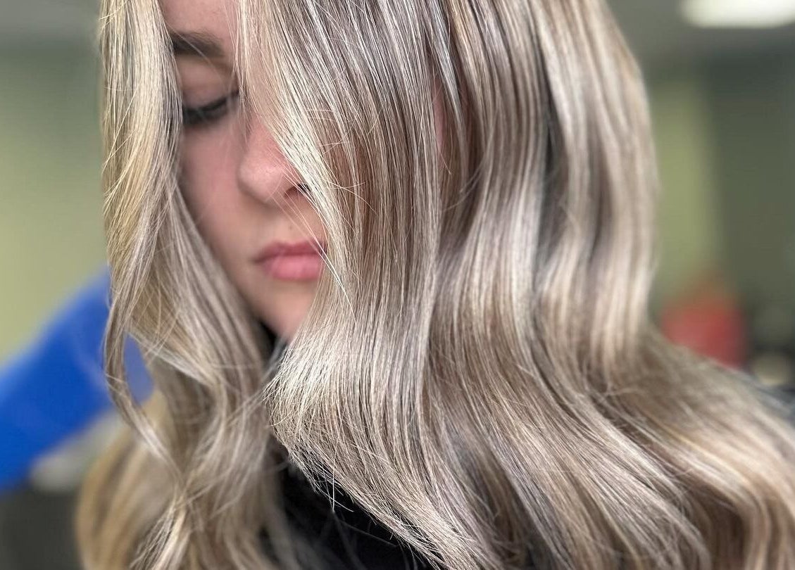 Close-up of shiny blonde hair at Ivy Studio in Shaw, England, GB, highlighting expertly styled smooth waves.