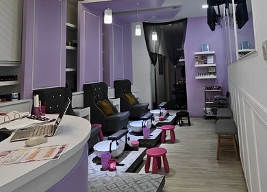 Elegant interior of Q Nails in Kuala Lumpur, showcasing lavender decor and comfortable seating for a relaxing experience.