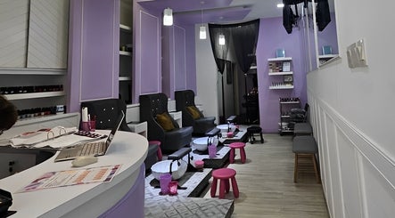 Elegant interior of Q Nails in Kuala Lumpur, showcasing lavender decor and comfortable seating for a relaxing experience.