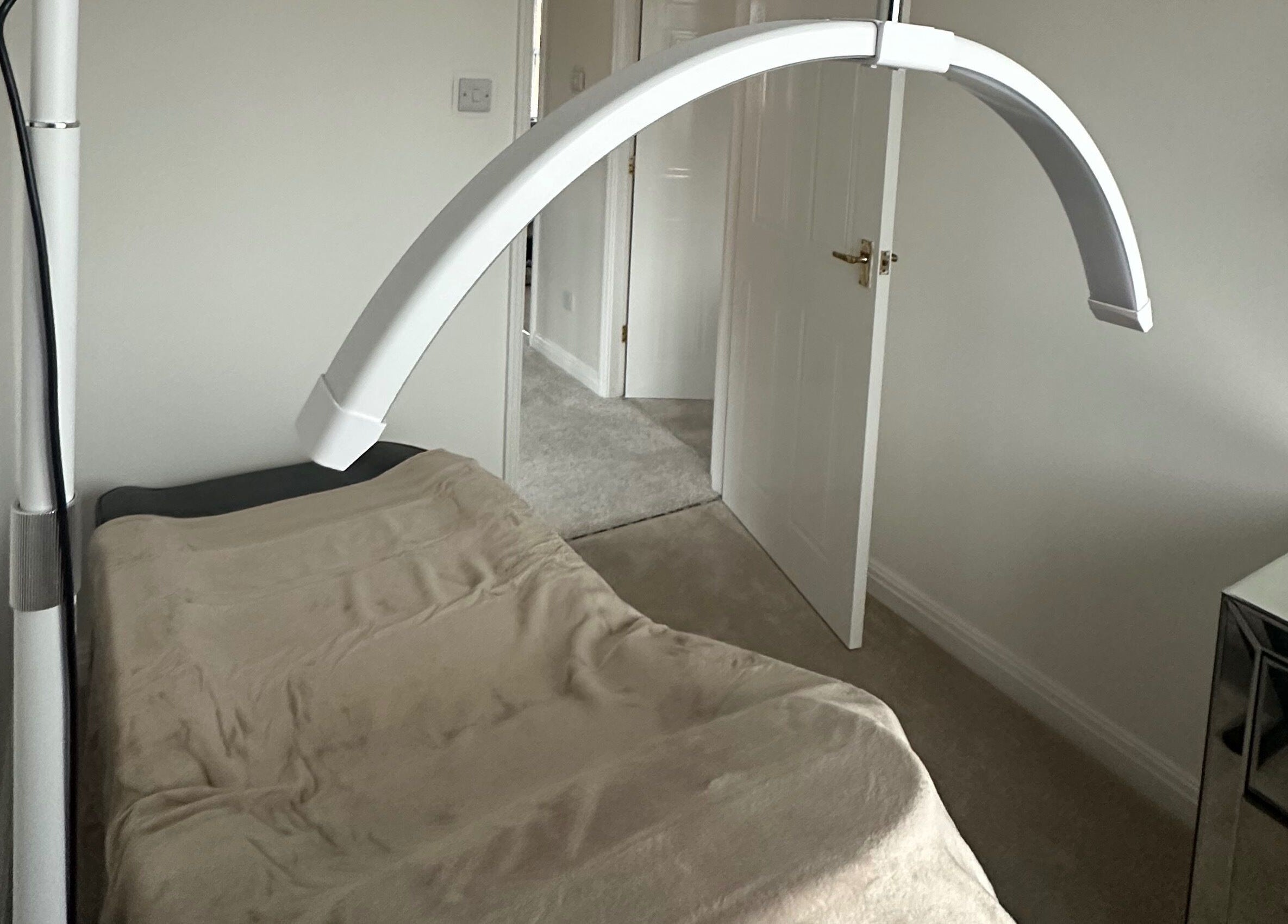 Treatment bed under soft light at Cheshire Brow Bar, Winsford, England, GB, ideal for relaxing therapies.