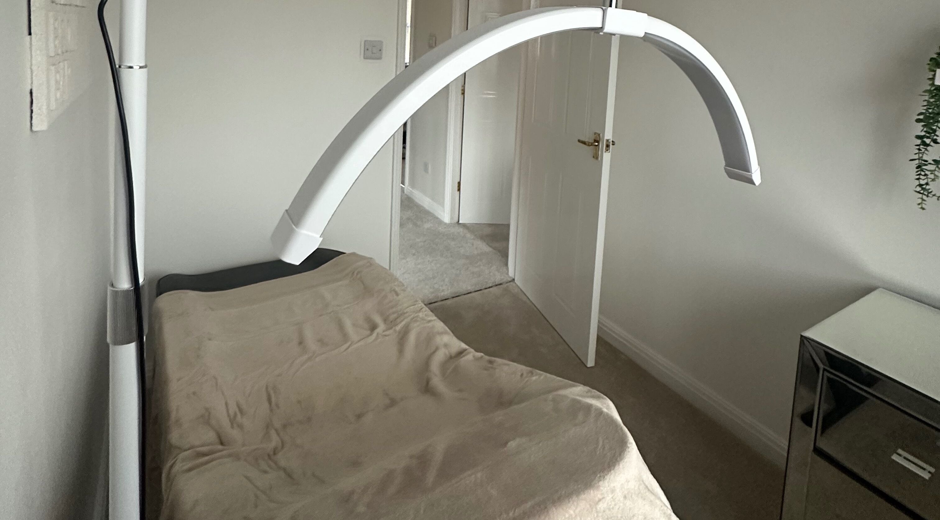 Treatment bed under soft light at Cheshire Brow Bar, Winsford, England, GB, ideal for relaxing therapies.