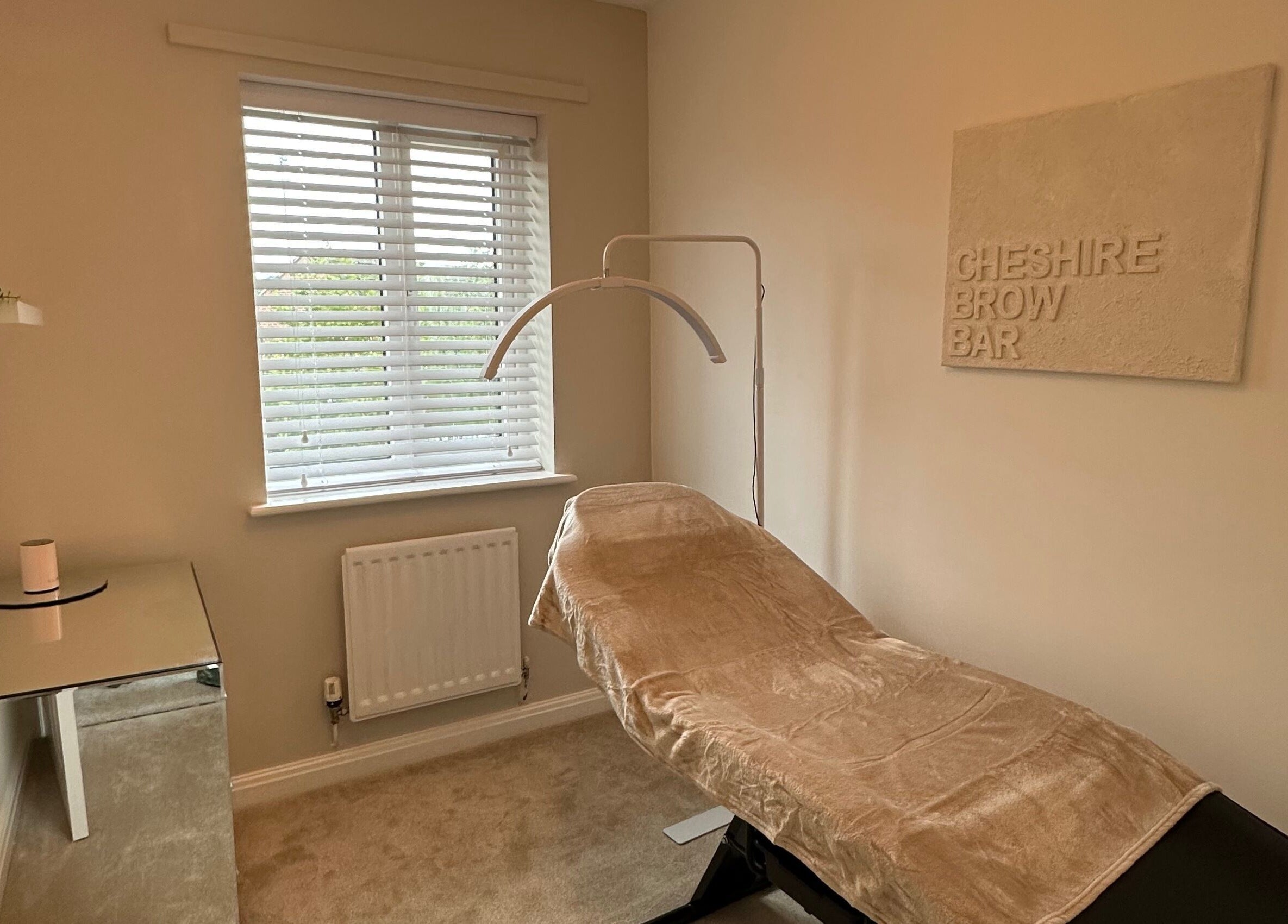 Cozy treatment room at Cheshire Brow Bar in Winsford, England, GB, featuring a comfortable chair and ambient decor.