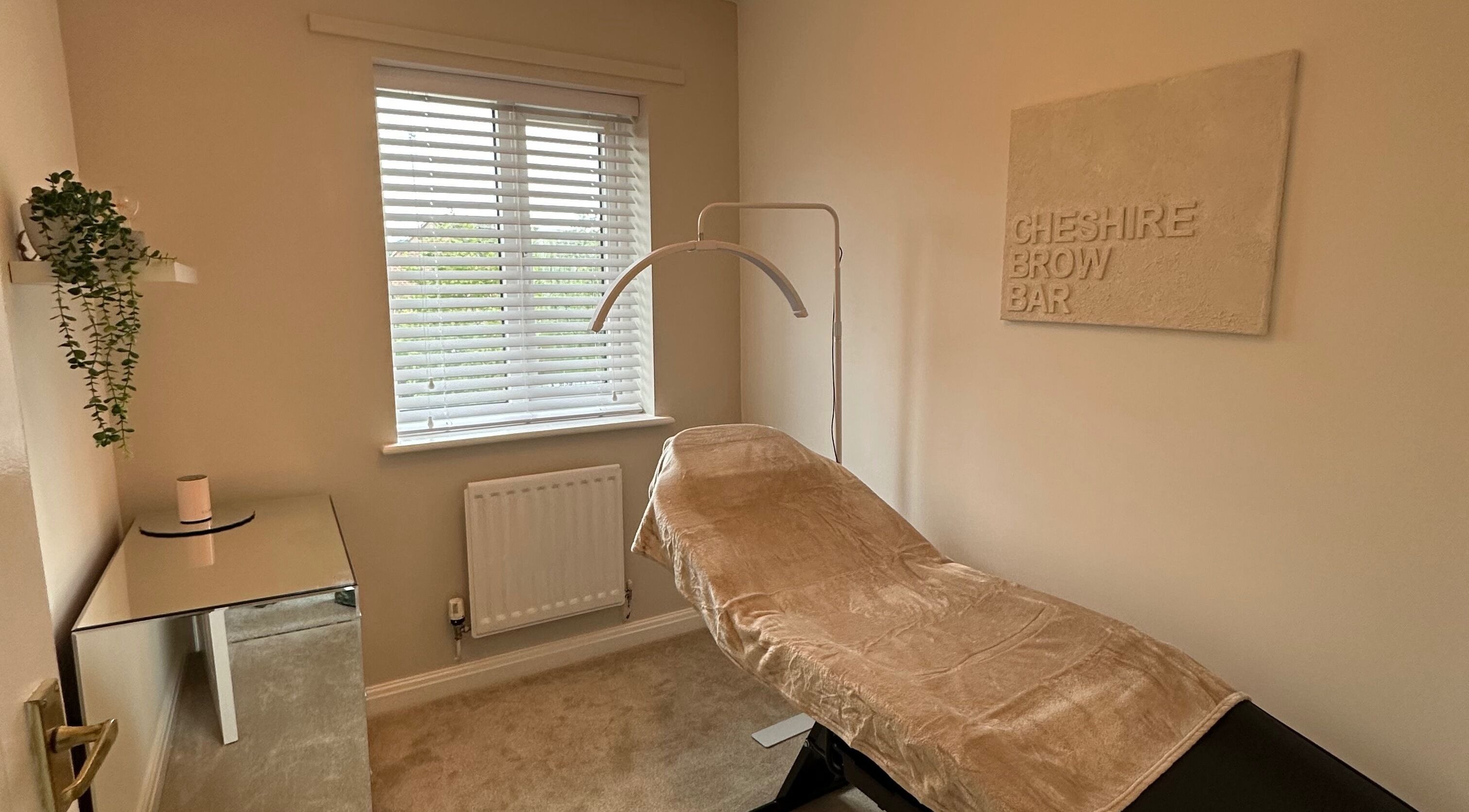 Cozy treatment room at Cheshire Brow Bar in Winsford, England, GB, featuring a comfortable chair and ambient decor.