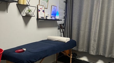 Massage therapy room at Hands Of Chid, Singapore, SG. Features cozy table and soothing ambiance.