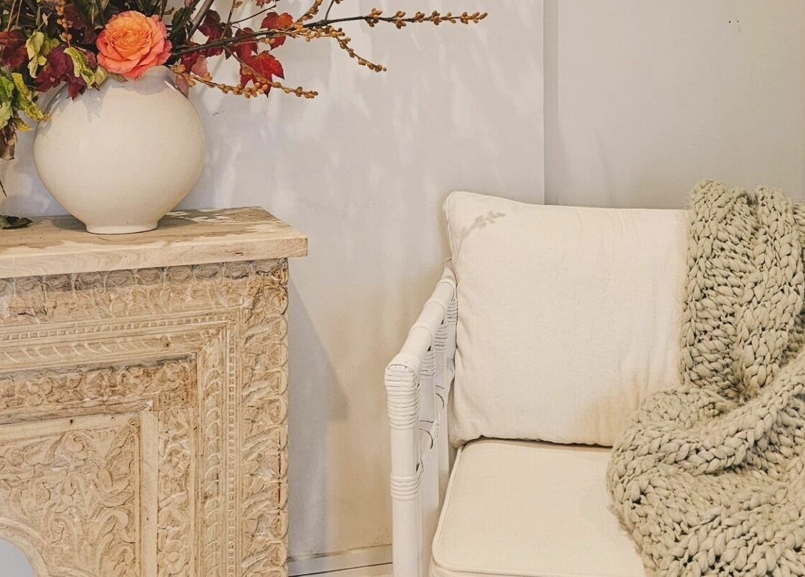 Cozy corner with ornate mantel and plush chair at Slow by Seed, Orange, New South Wales, AU.