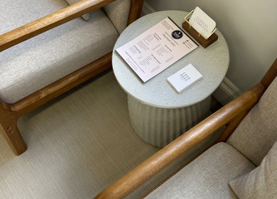 Lounge chairs and table at COCO ROSE BEAUTY, St Austell, England, GB, showcasing a tranquil waiting area.