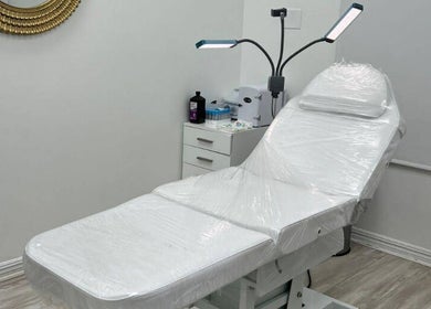 Treatment room at Harmony Medical Spa in Doral, Florida, US with a sleek white chair and modern decor.