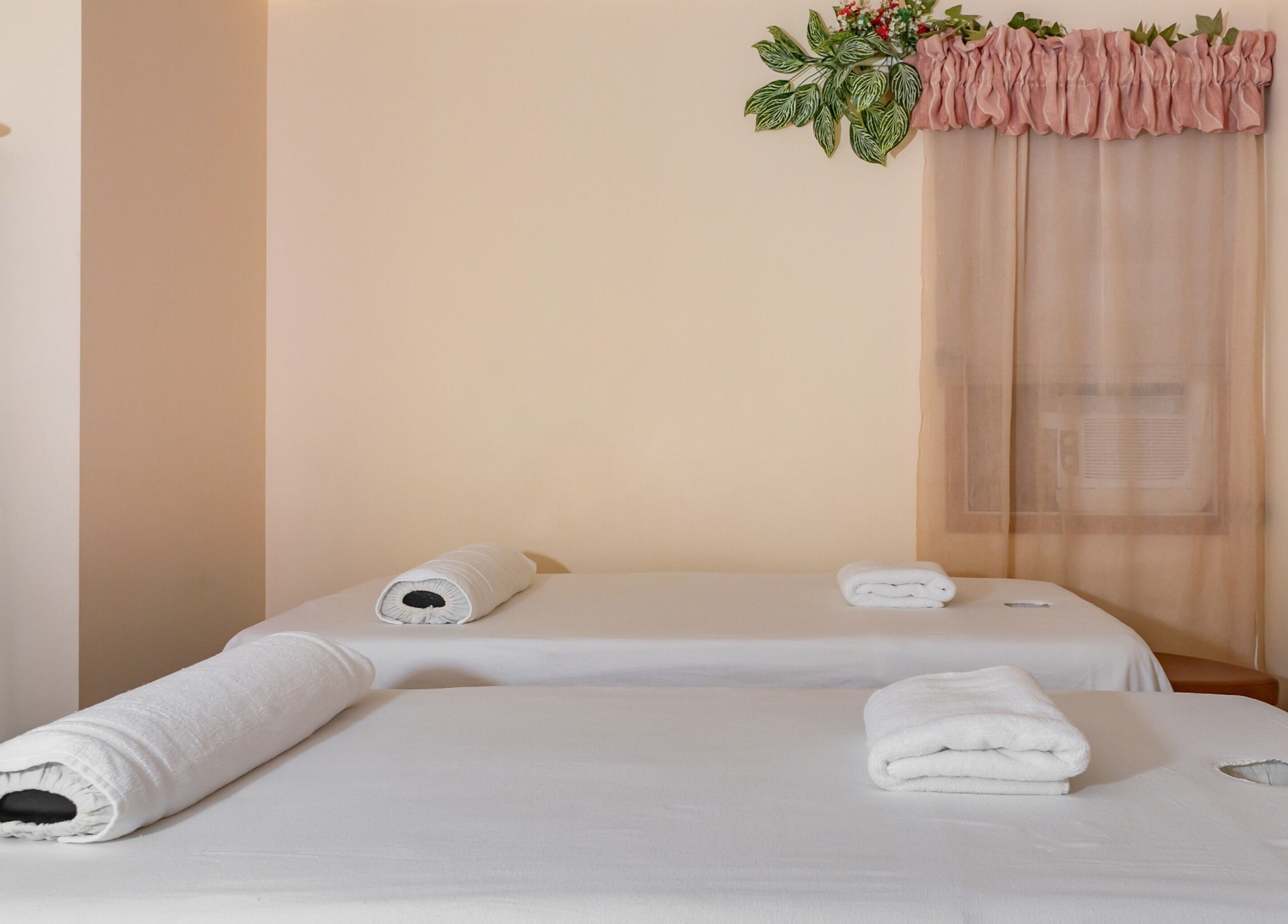 Tranquil massage room at Massage by Anna Ltd, Red Deer, Alberta, CA with two prepared tables.