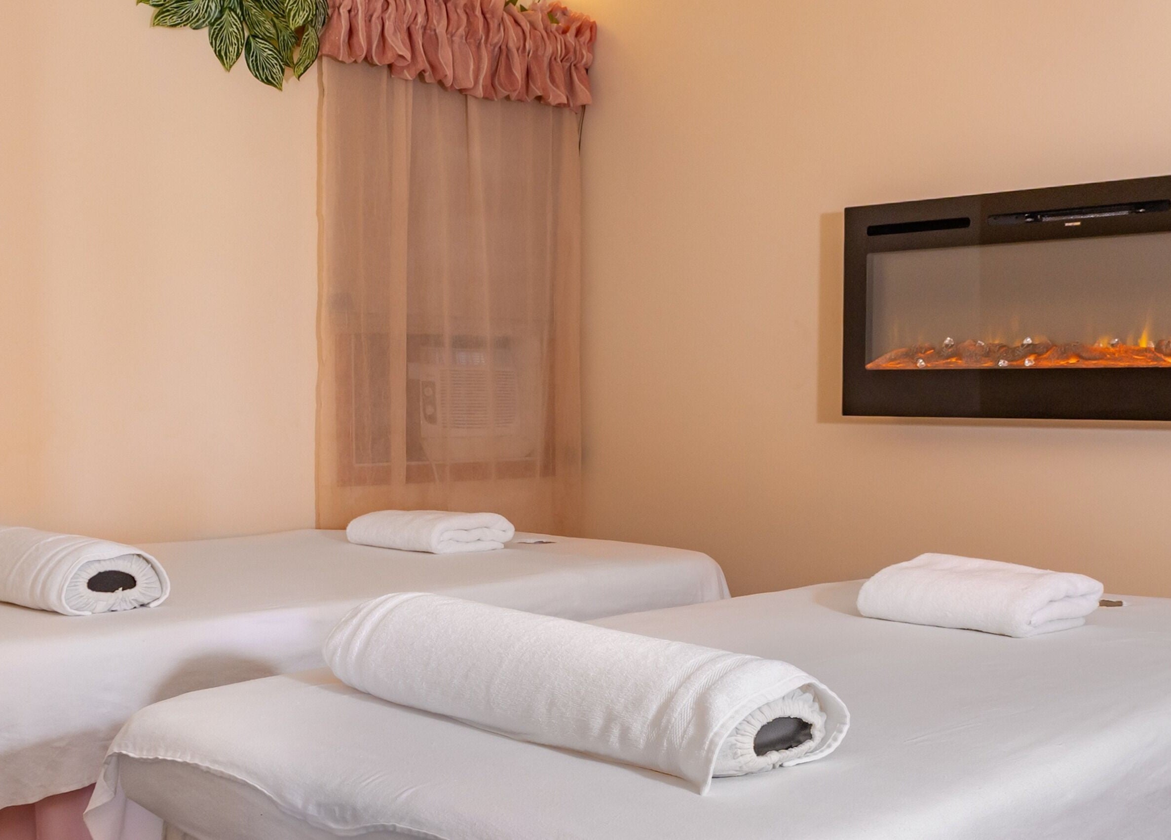 Serene massage room at Massage by Anna Ltd, Red Deer, Alberta, CA, featuring two tables and calming decor.