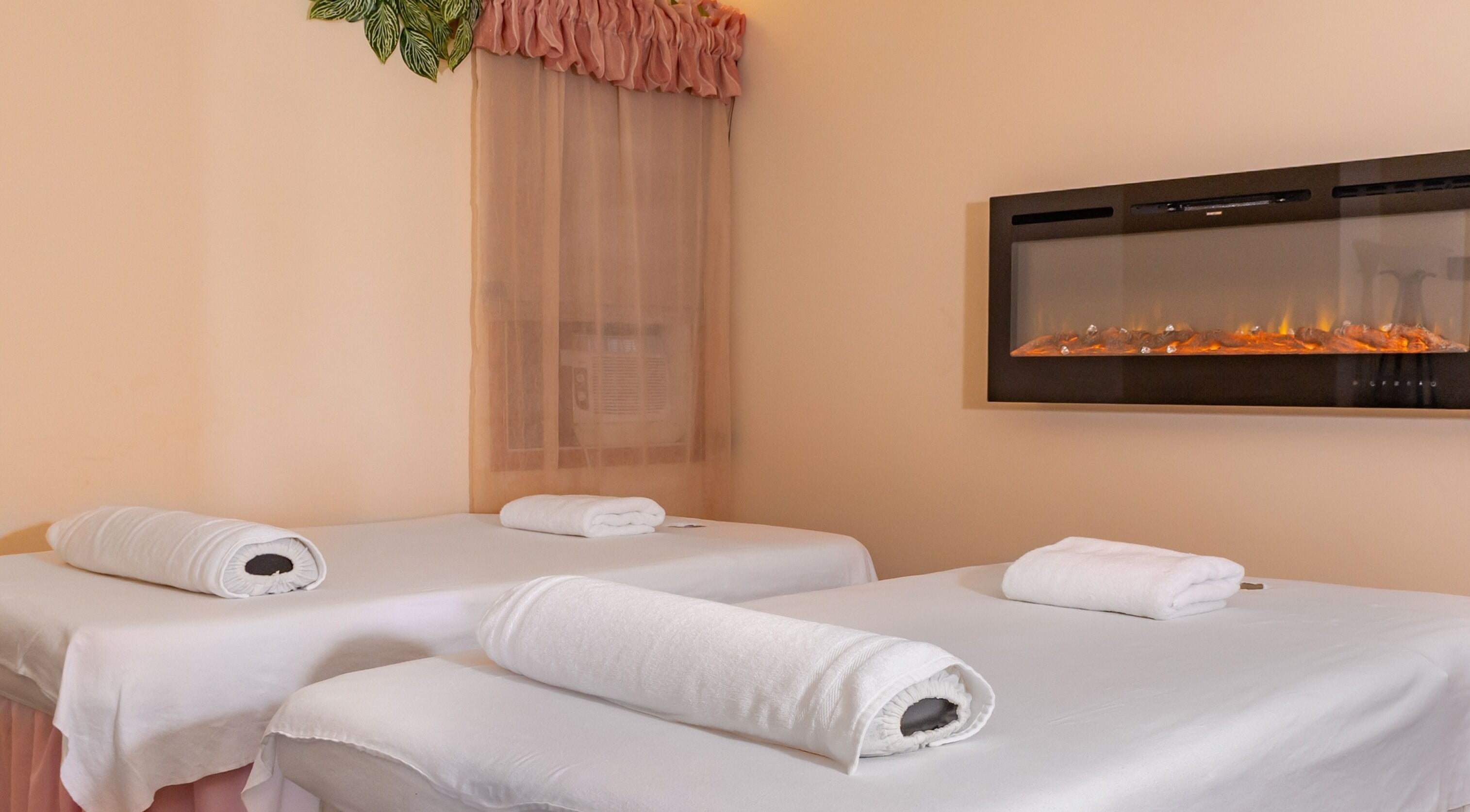 Serene massage room at Massage by Anna Ltd, Red Deer, Alberta, CA, featuring two tables and calming decor.