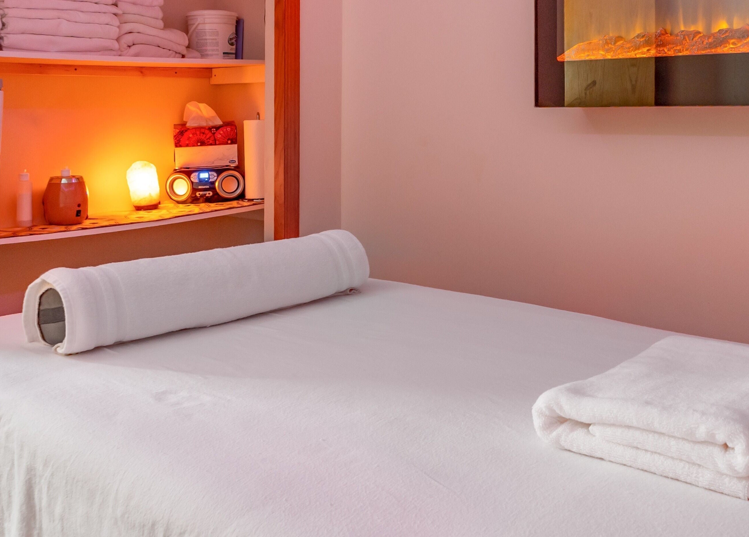 Cozy massage room at Massage by Anna Ltd in Red Deer, Alberta, CA with warm lighting and soft towels.