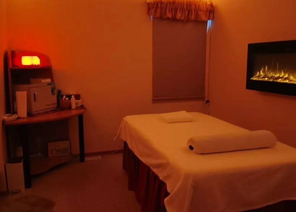 Tranquil massage room at Massage by Anna Ltd, Red Deer, Alberta, CA, with soft lighting and cozy decor.