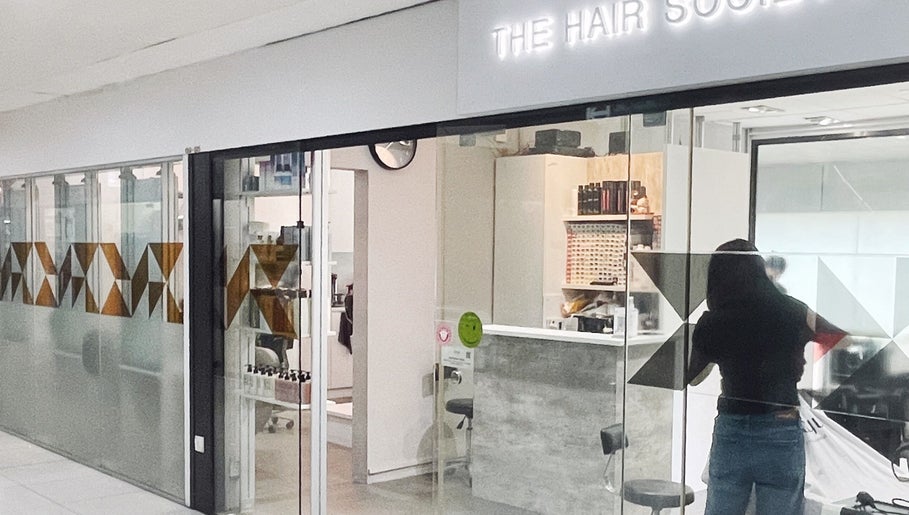 Entrance to The Hair Society, a chic salon in Singapore, Singapore, SG, showcasing modern design elements.