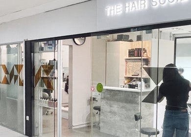 Entrance to The Hair Society, a chic salon in Singapore, Singapore, SG, showcasing modern design elements.