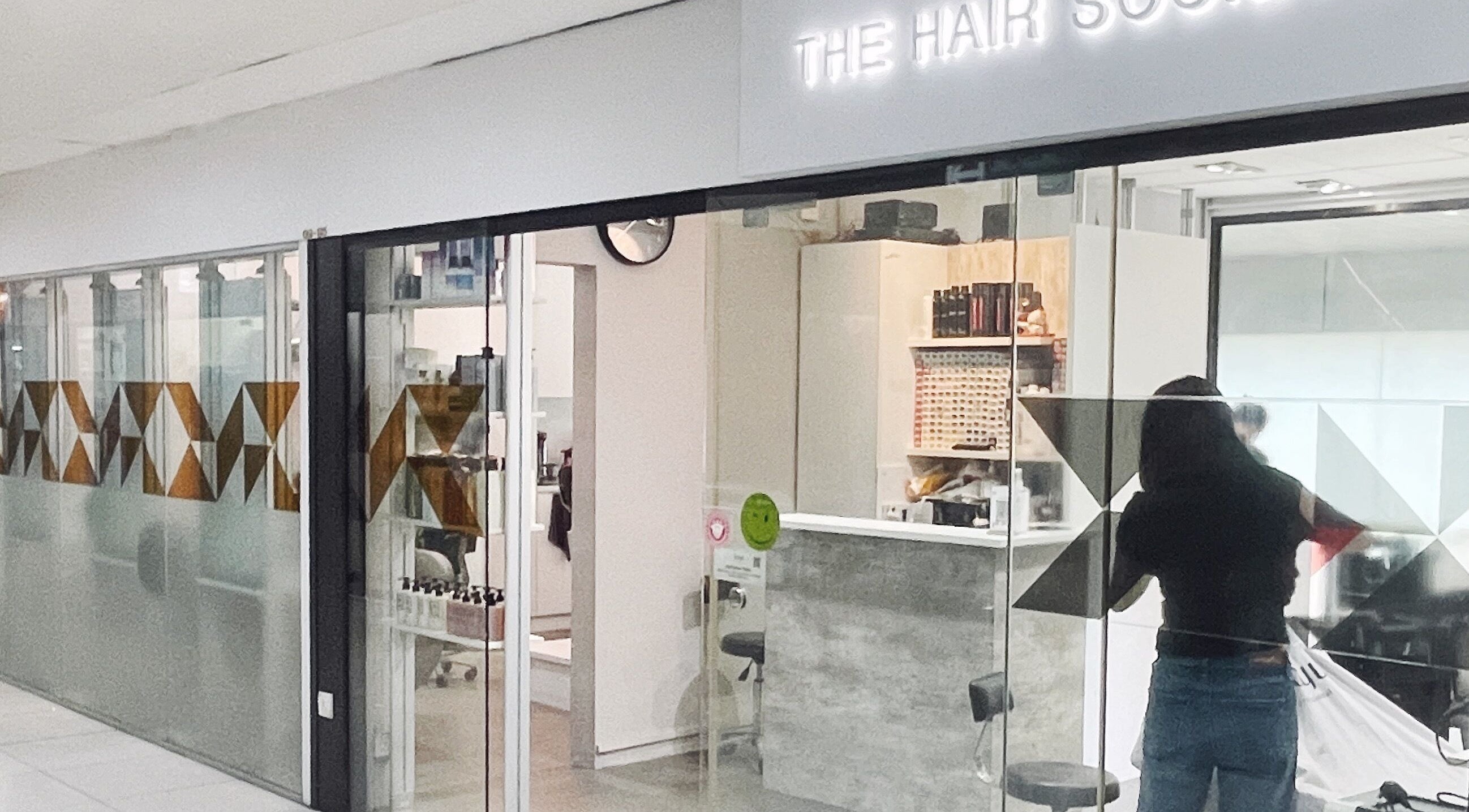 Entrance to The Hair Society, a chic salon in Singapore, Singapore, SG, showcasing modern design elements.