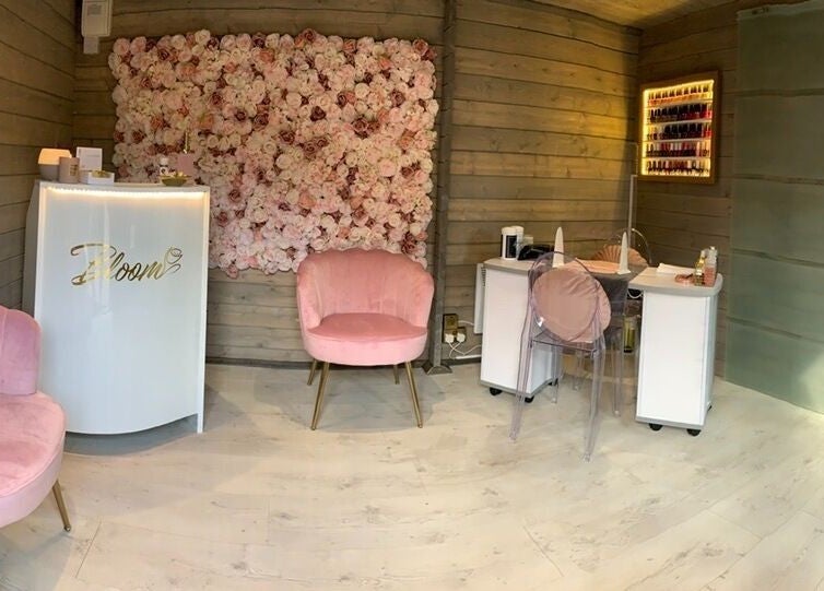 Chic interior of Bloom Beauty Studio with pink chairs and a floral wall in The Royal Town of Sutton Coldfield, England, GB.
