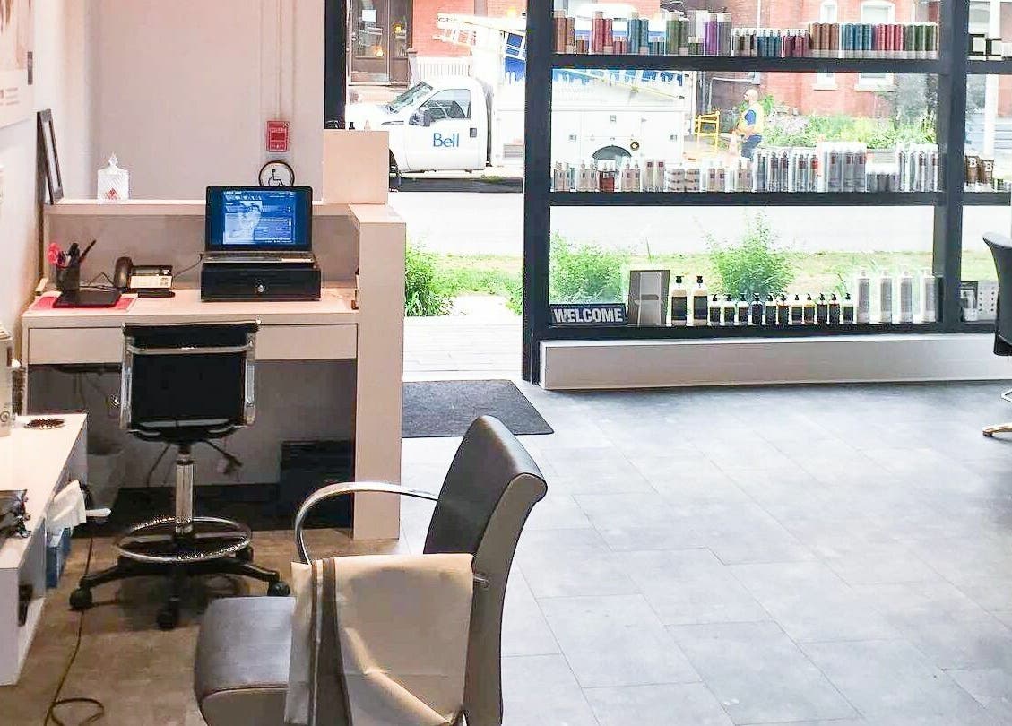 Bright, inviting interior of Maneland in Ottawa, Ontario, CA, featuring chic workstations and product displays.
