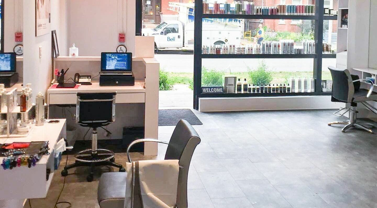 Bright, inviting interior of Maneland in Ottawa, Ontario, CA, featuring chic workstations and product displays.