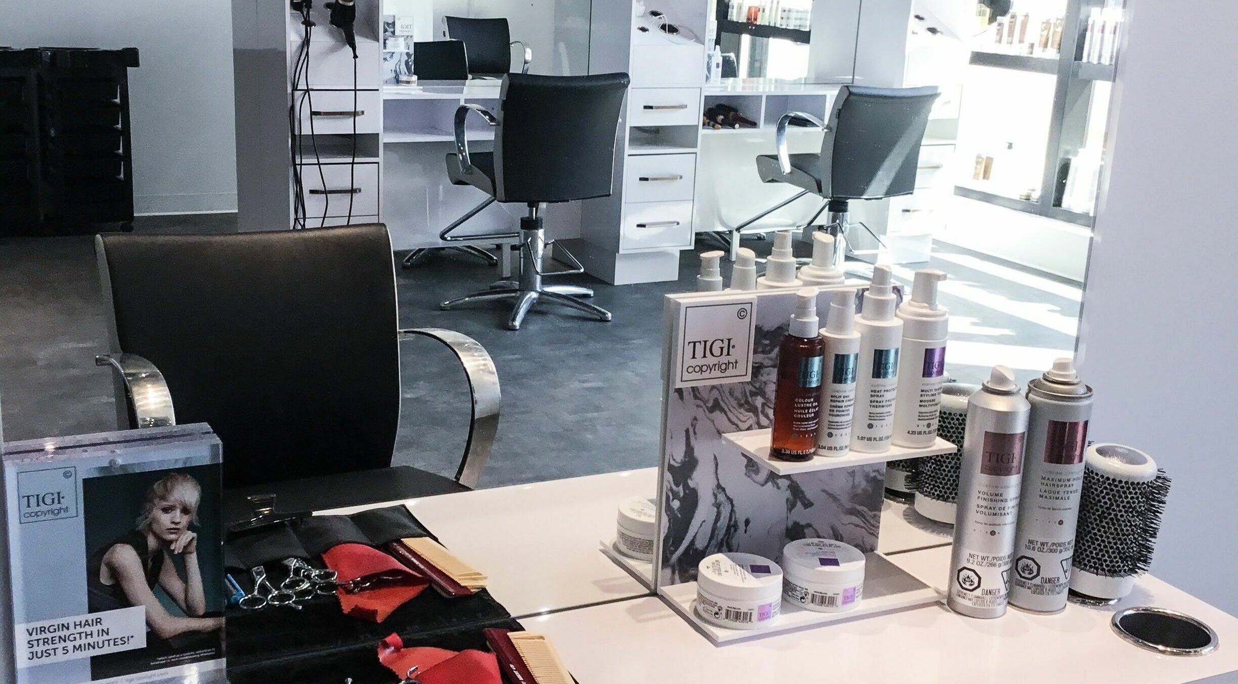 Chic salon station at Maneland, Ottawa, Ontario, CA, featuring elegant styling tools and products.