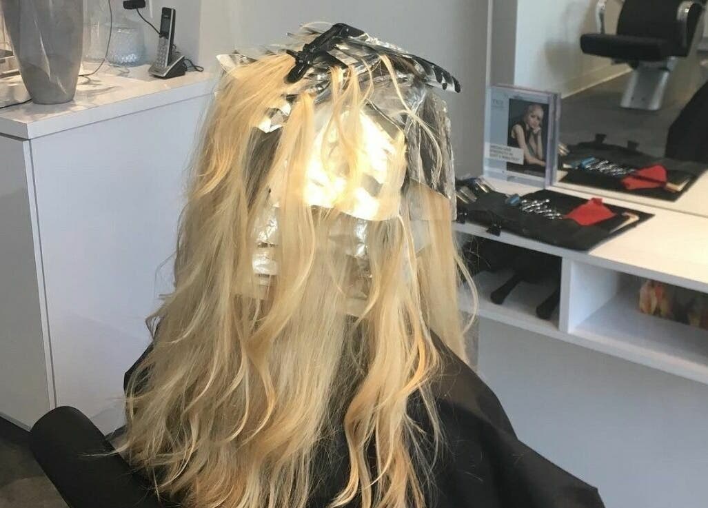 Hair highlighting in progress at Maneland, Ottawa, Ontario, CA, showcasing salon expertise.