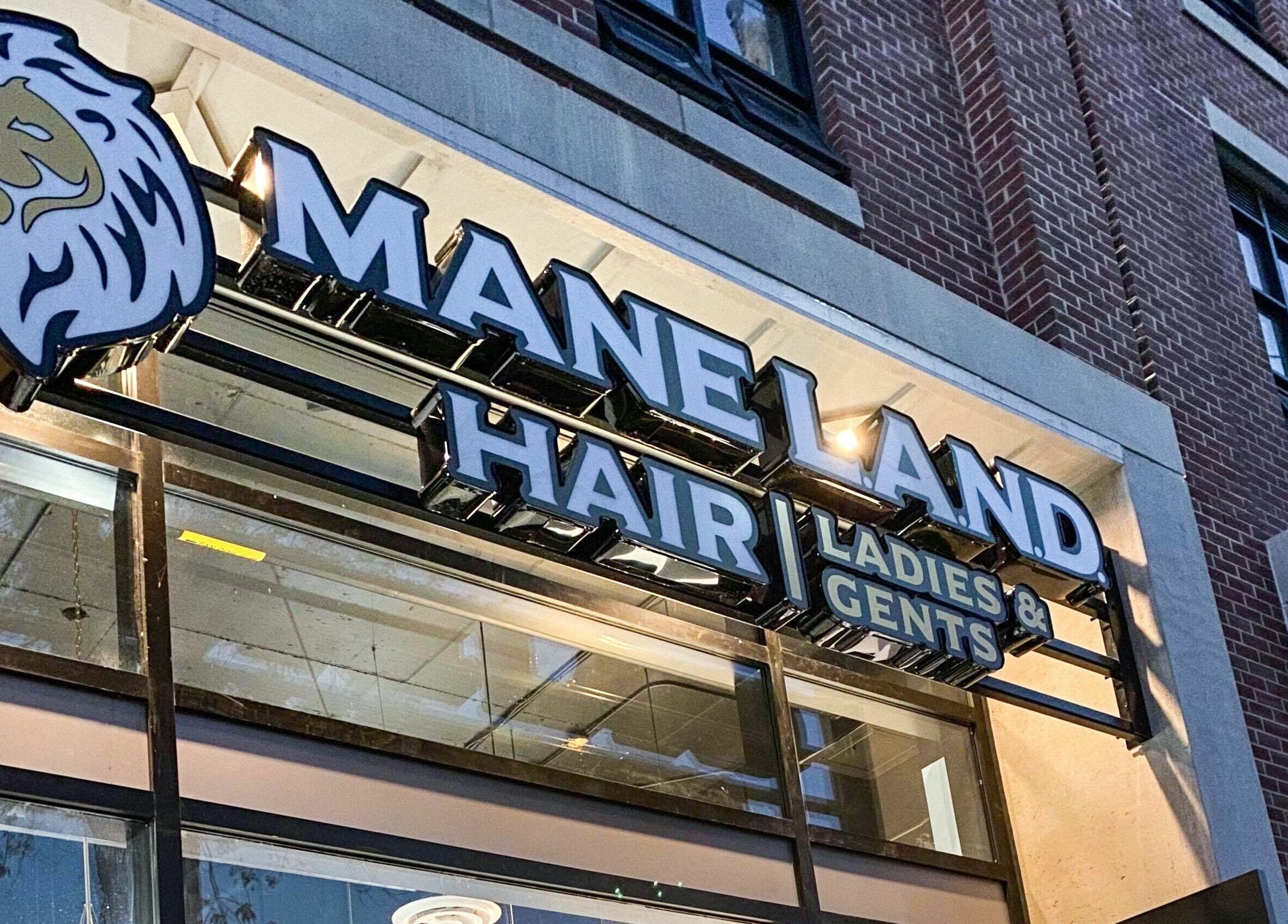 Exterior sign of Maneland hair salon in Ottawa, Ontario, CA, showcasing stylish branding.