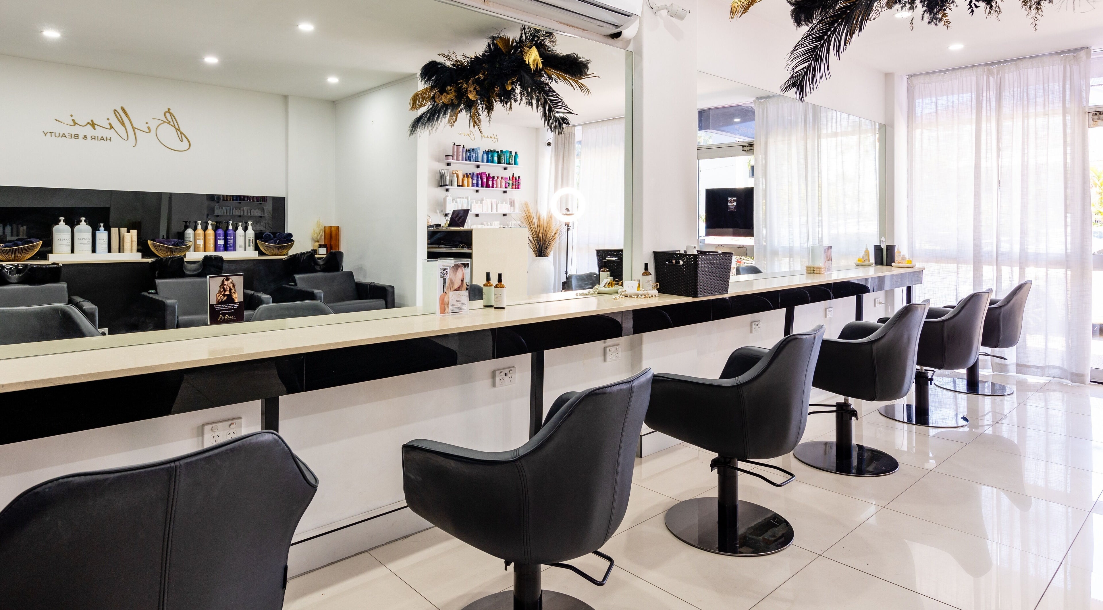 Modern salon at Billini Hair and Beauty in Miami, Queensland, AU featuring sleek chairs and polished decor.