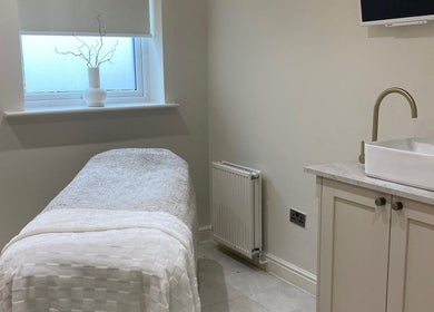 Serene treatment room at Atelier Hair & Beauty Studio in Bolton, England, GB, with a plush bed and stylish sink.